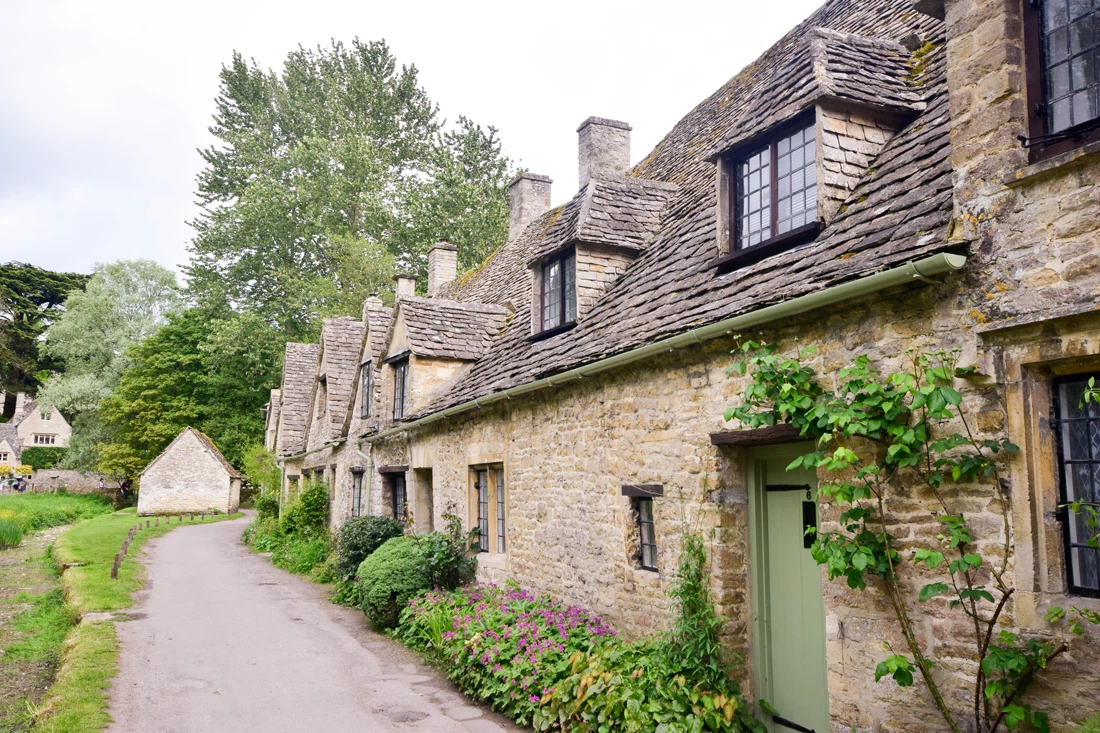A row of old stone houses in a village setting in the Cotswold's