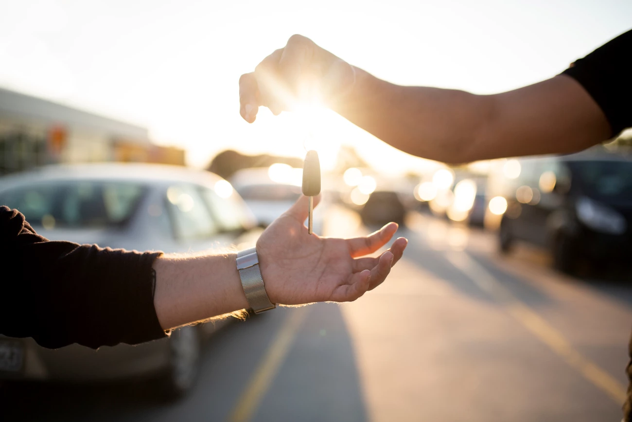 Car Keys Being Dropped Into Someones Hand