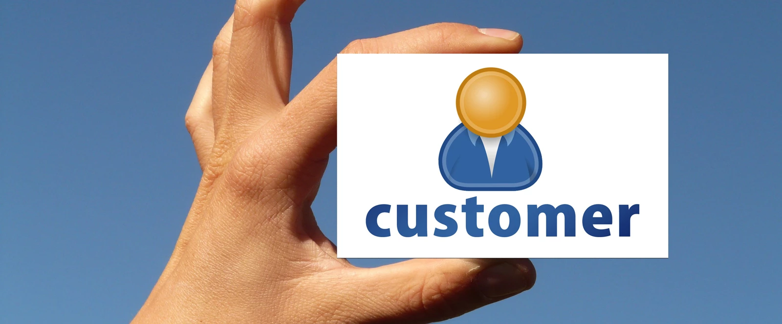 A hand holding a customer icon against a blue sky