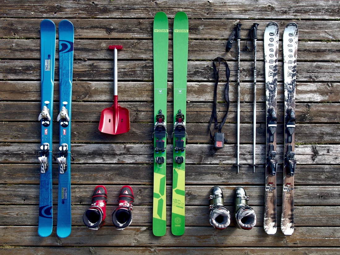 Ski equipment essentials laid out on wooden flooring