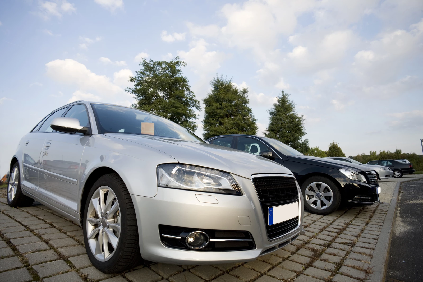 A forecourt of cars for sale at a motor trade business