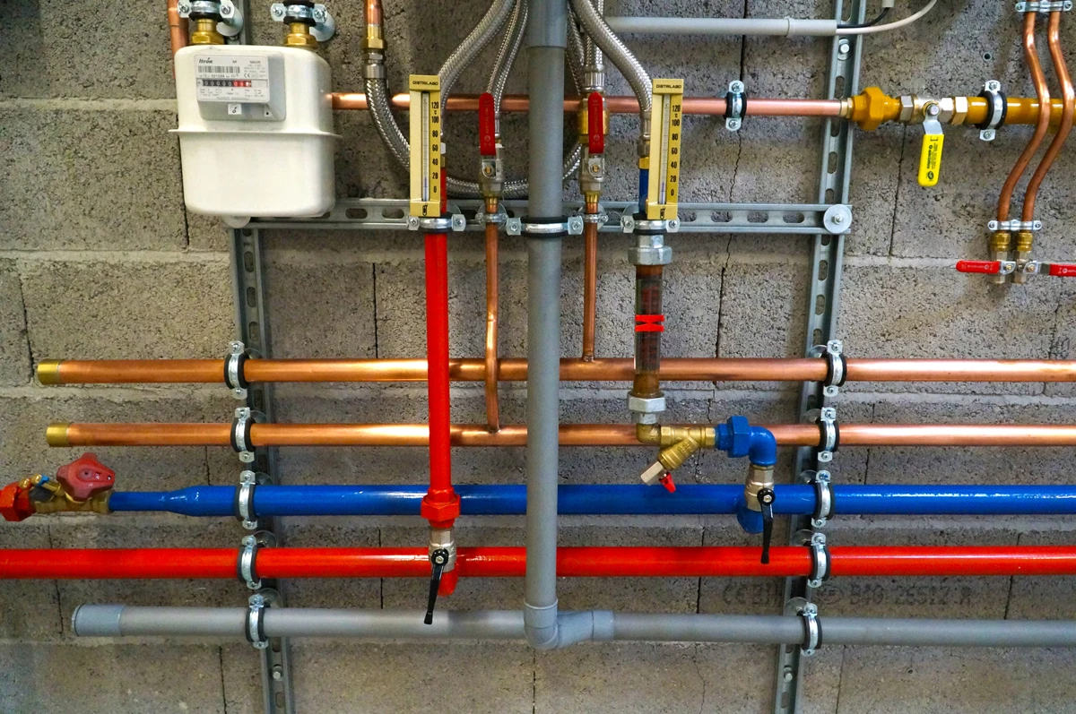 A wall with plumbing piping installed