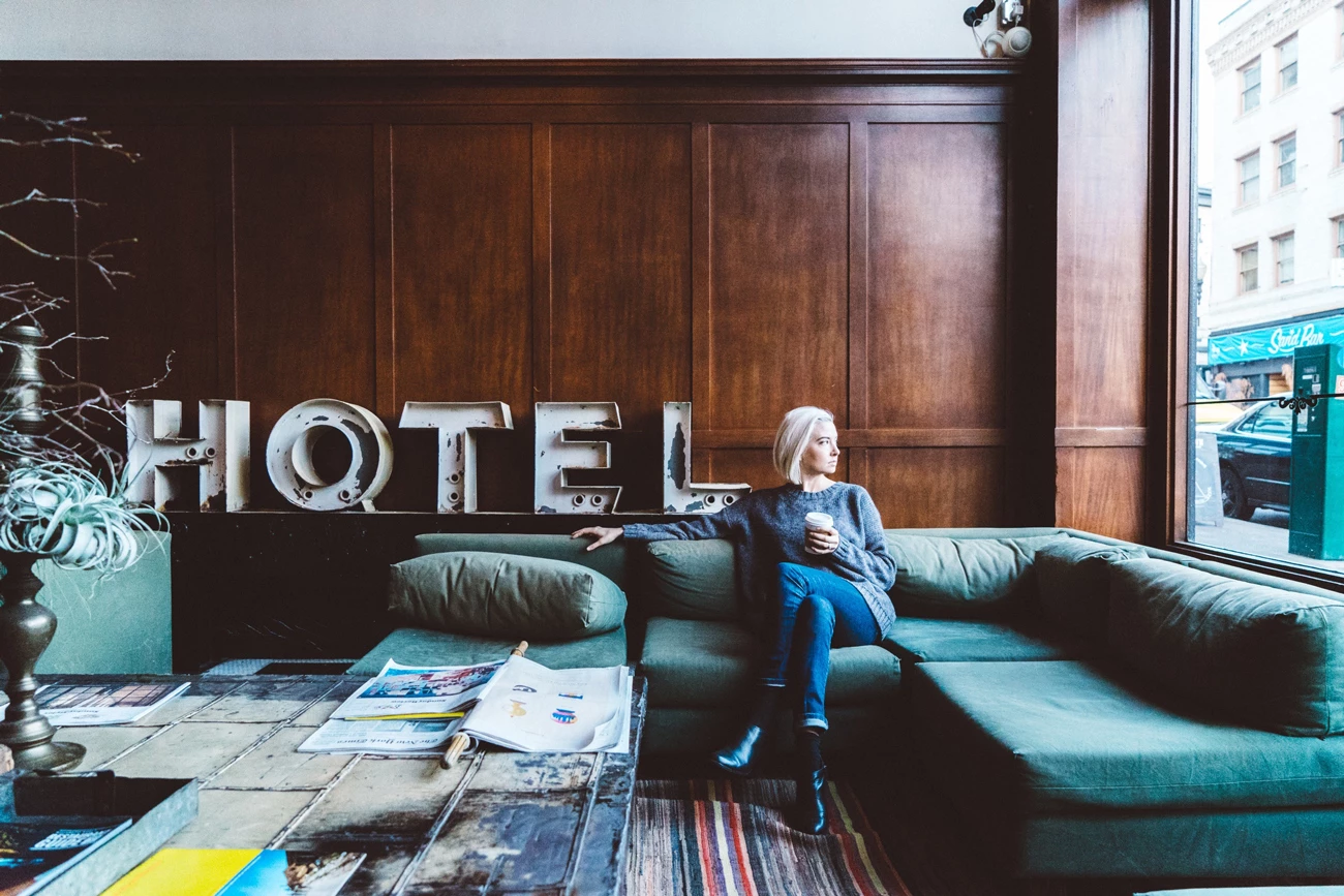 A person sitting in a hotel lobby on a sofa