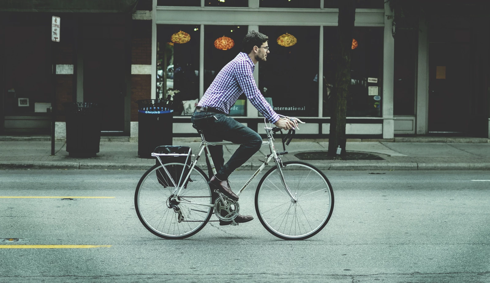 A man commuting on a bicycle through a city