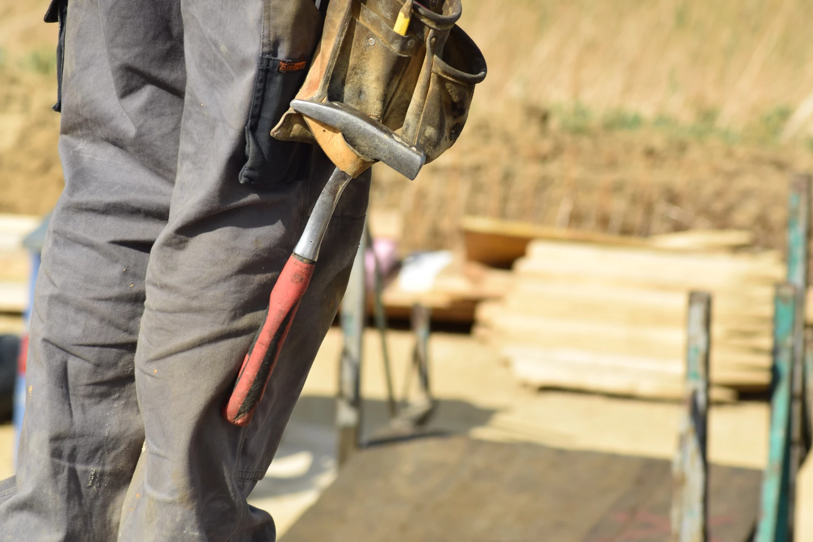 A construction worker looking down on a work site