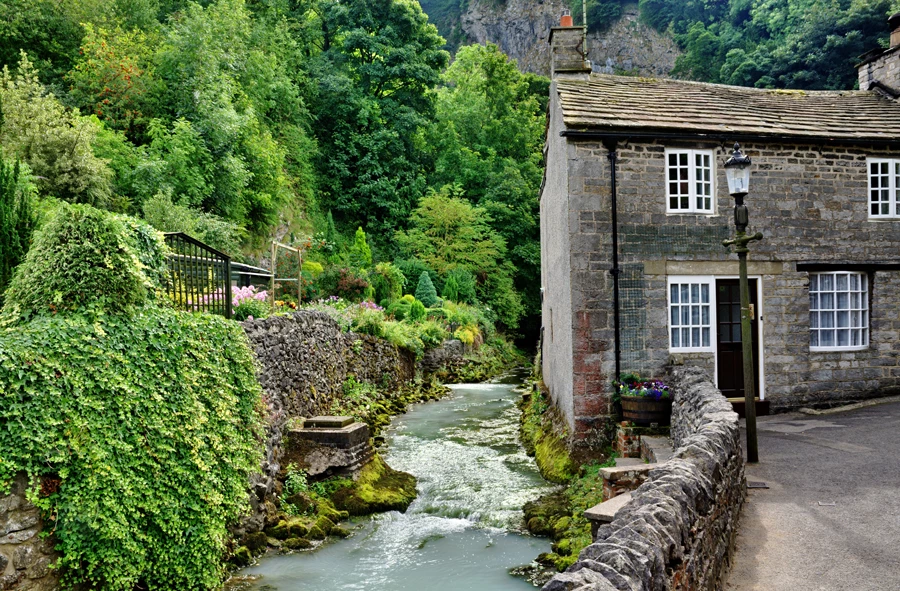A stone building at flood risk next to a river