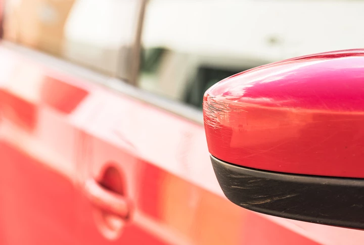 A damaged wing mirror of a car for sale