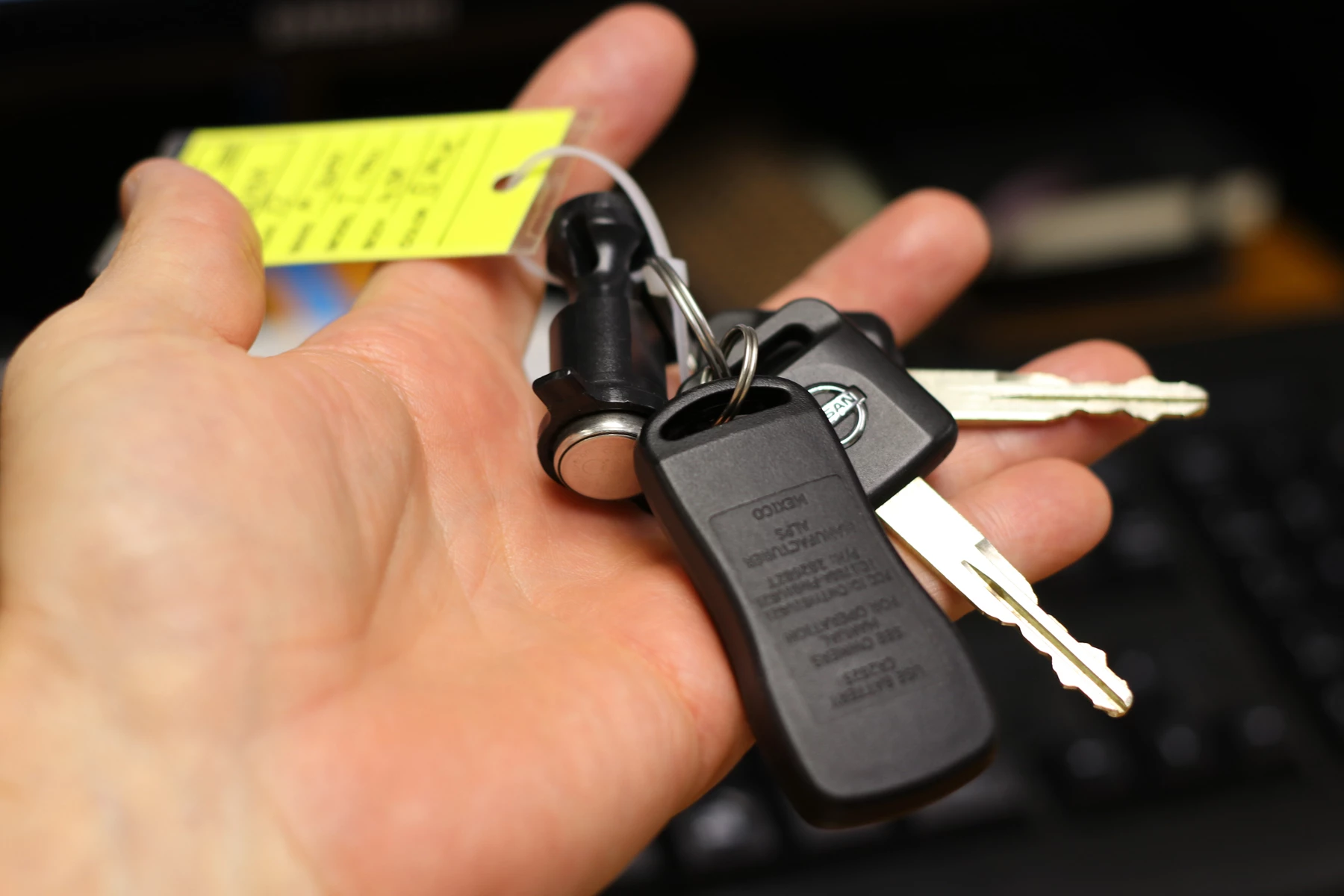 A car salesman holding the keys to a new car 