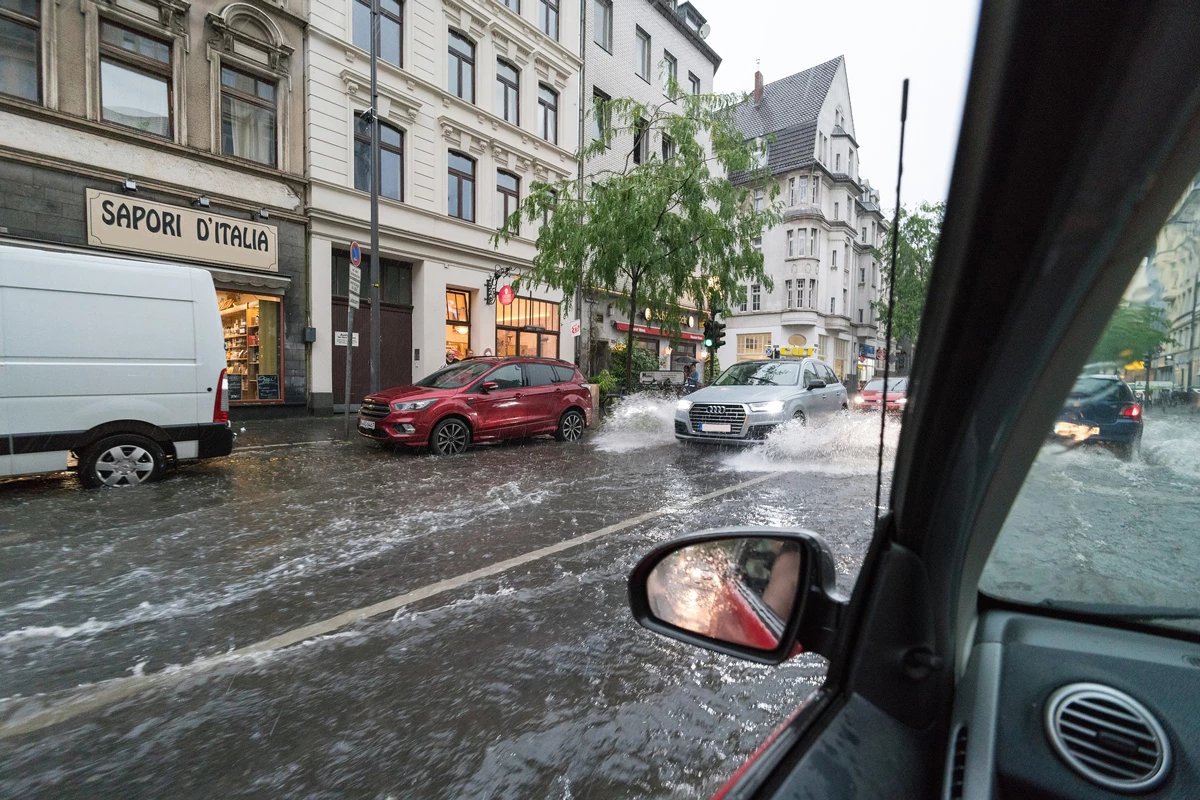A flooded high street with busy traffic 