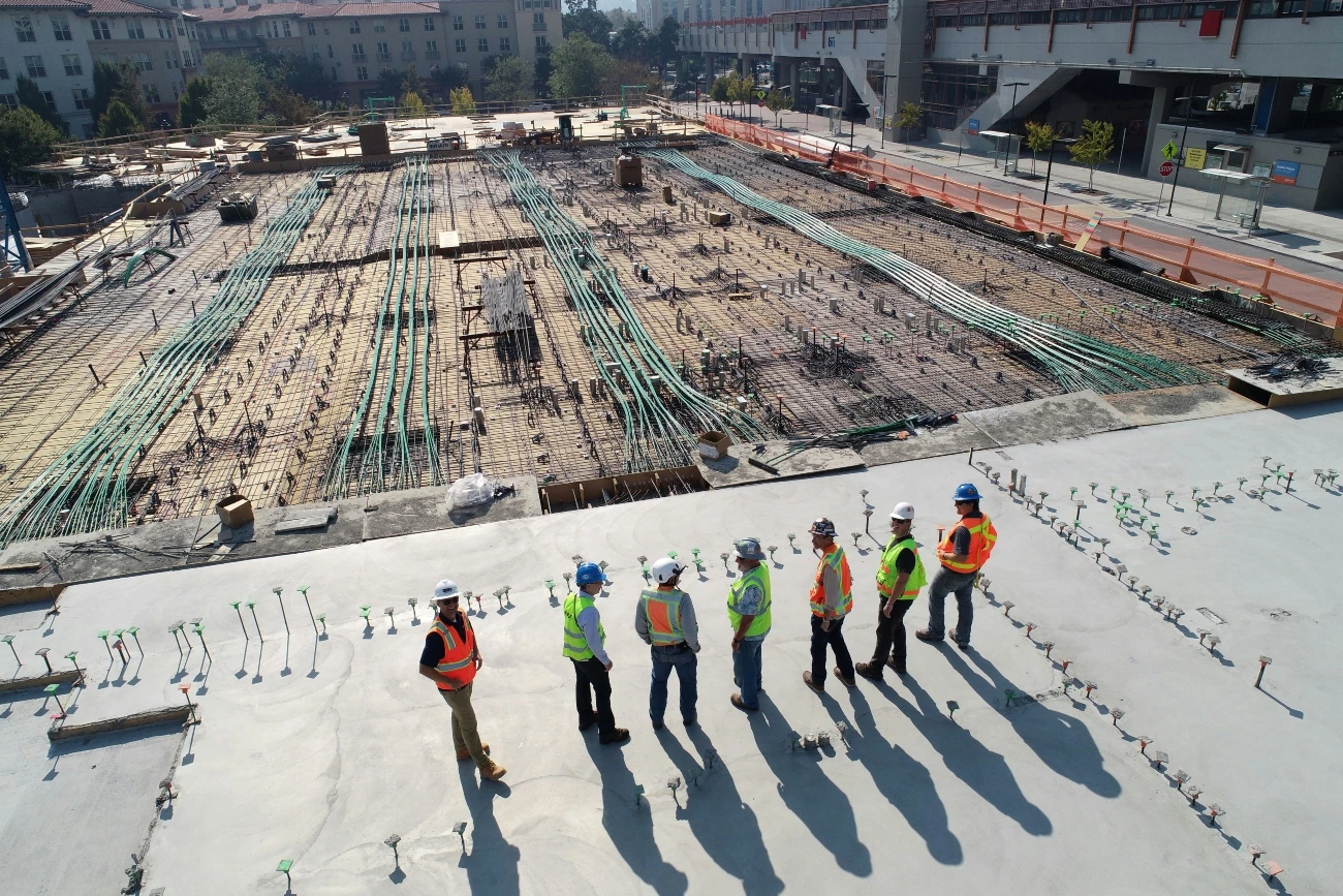 Contractors Looking Over At A Construction Site