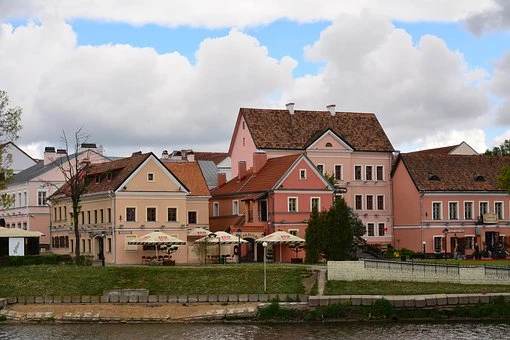 A town across a river with light pink coloured housing in Minsk, Belarus