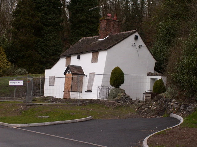 slanted white house in the country surrounded by safety fence due to subsidence
