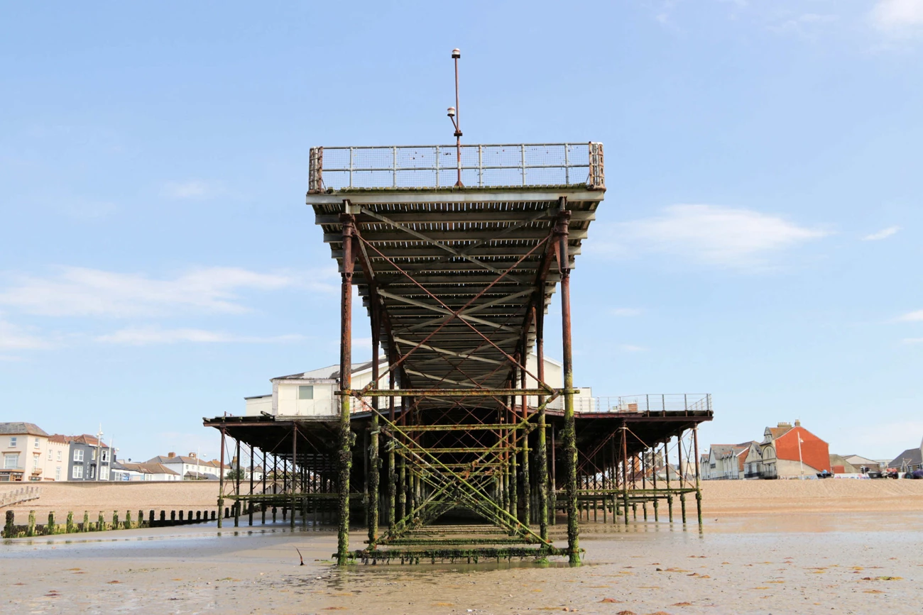 A algae covered pier reaching out from the shore line at Bognor Regis